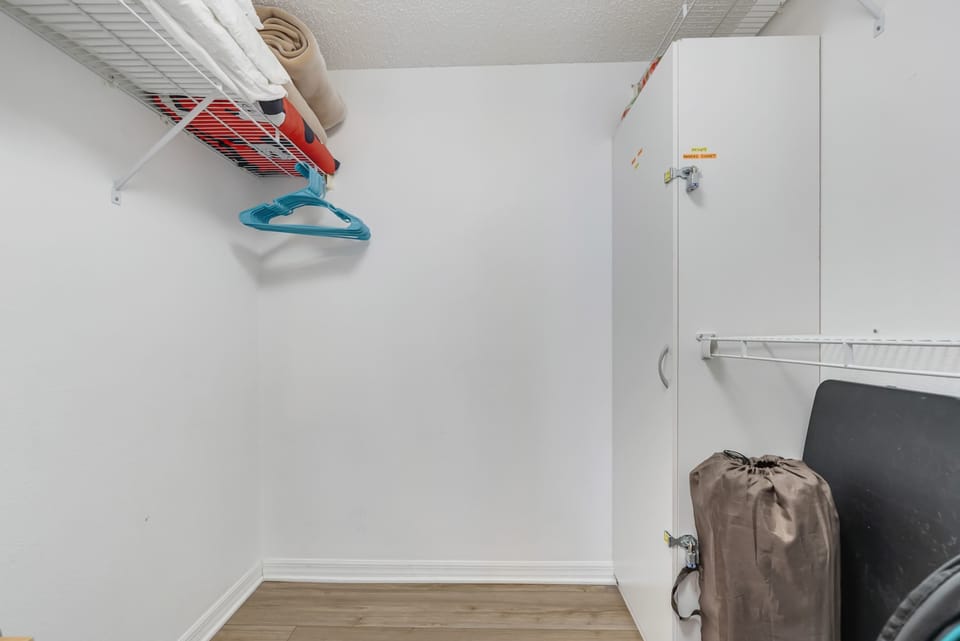 Functional closet space with shelving and hangers for organized storage.