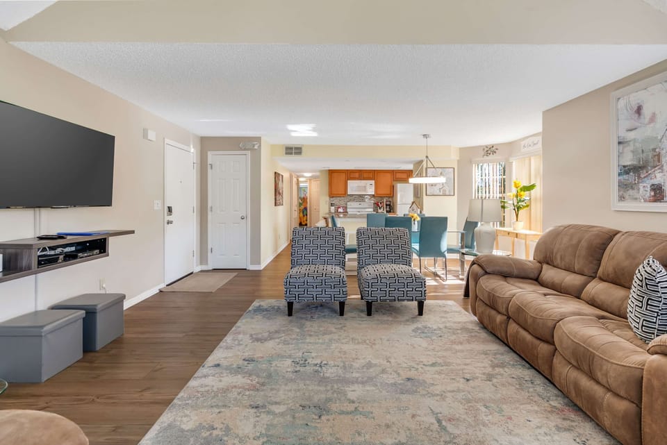 Open-concept living and dining area with modern furnishings and natural light