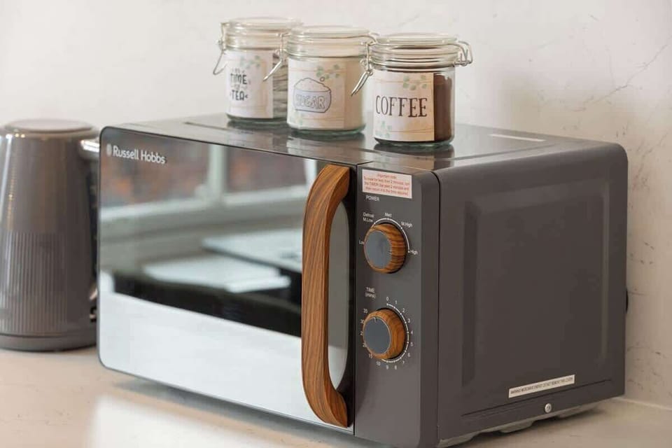 A sleek, modern kitchenette equipped with microwave, kettle and essentials for light cooking. Perfect for preparing breakfast, snacks or drinks, offering convenience and comfort within this stylish, self-contained living space