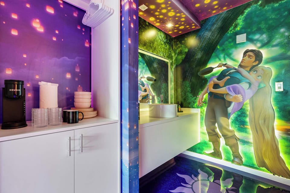 A themed kitchenette area with a keurig coffee maker and a mural inspired by a popular animated film.
