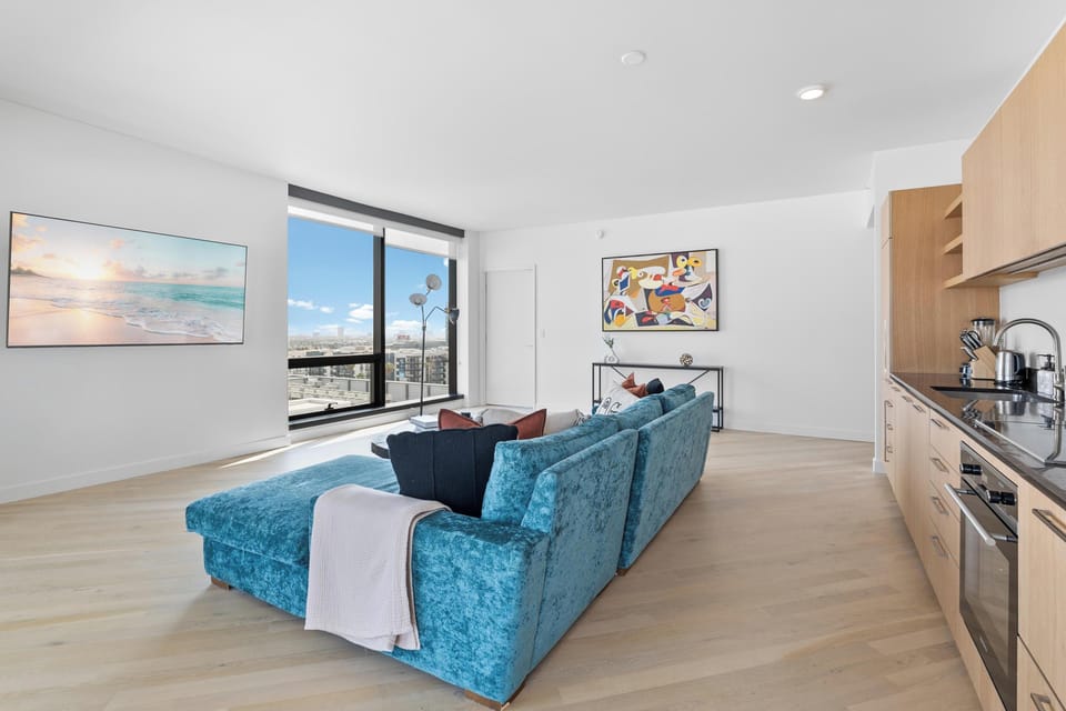 Relax in style with 65" entertainment and breathtaking city views.