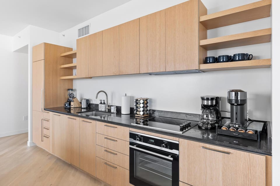 Fully equipped kitchen with premium espresso machine and built-in appliances.