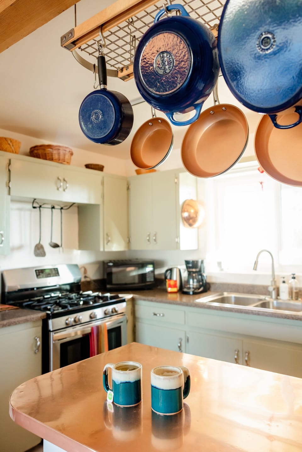 An island with a copper countertop and comfy stools so no one has to cook alone.