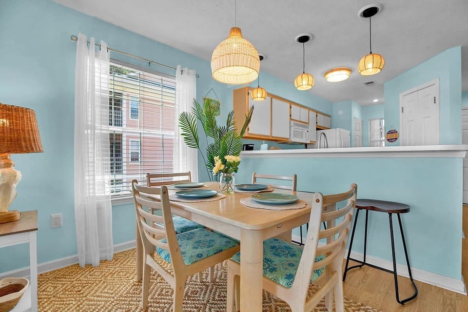 Enjoy meals, morning coffee, or evening drinks in this bright and inviting coastal-inspired dining area. With comfortable seating for four at the table plus additional bar seating, this open-concept space is perfect for gathering with family and friends. 