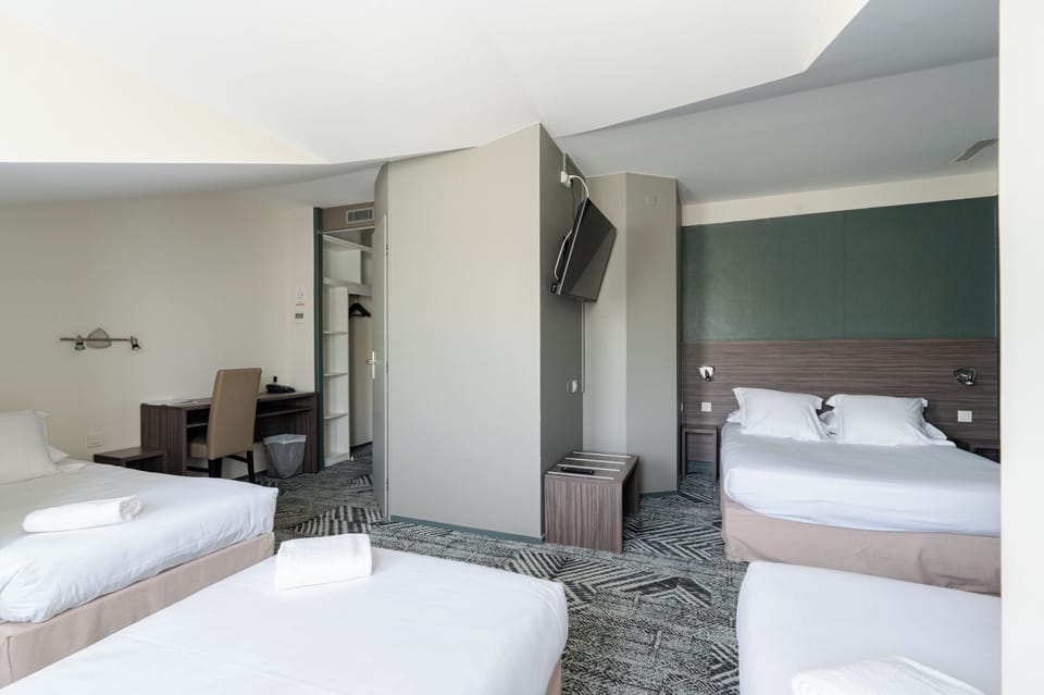 Family Room | Premium bedding, desk, laptop workspace, blackout drapes