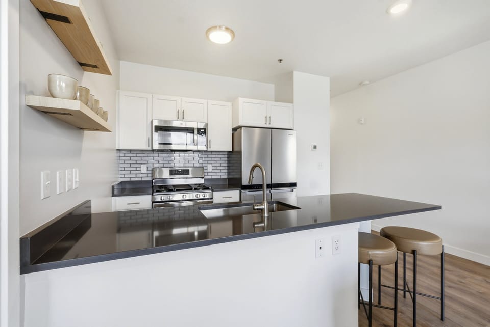 Modern kitchen with island seating, stainless steel appliances, and open layout for easy entertaining
