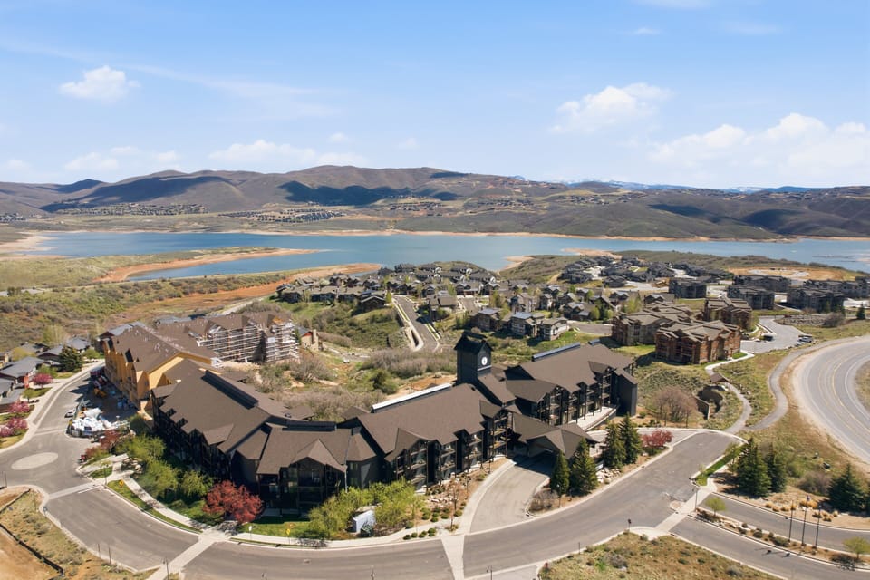 Aerial view of The Mason community with nearby lake and expansive Park City scenery