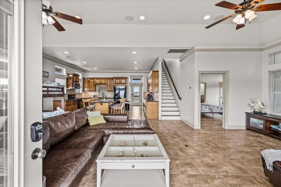 Open living space with seating & stairs – designed for large group vacation rentals Texas coast