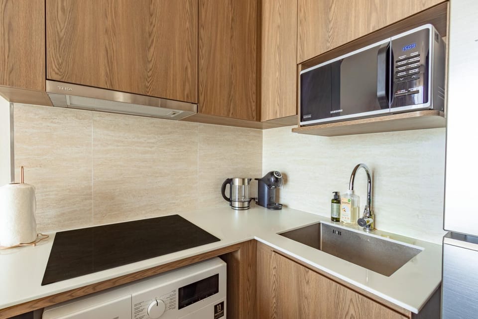 Modern kitchen with built-in appliances, ample storage, and clean finishes.