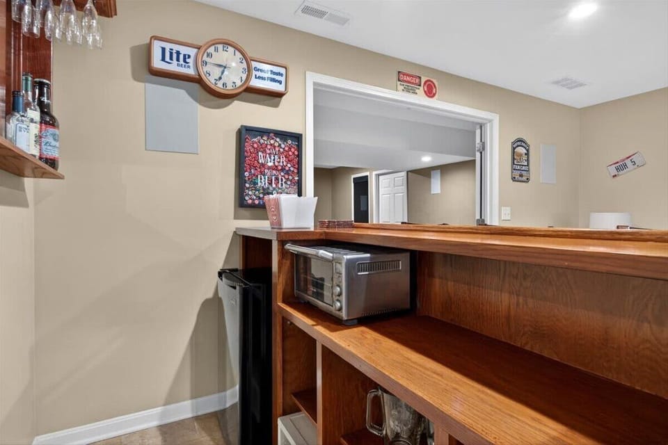 Game Room: Step into the ultimate game room featuring a pool table, poker table, bar area, and TV, creating the perfect space for entertainment, friendly competition, and unforgettable nights in.