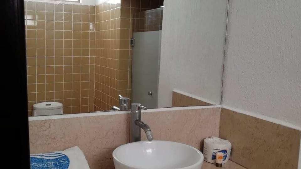 Refresh in a clean bathroom with roomy mirror and vanity space.