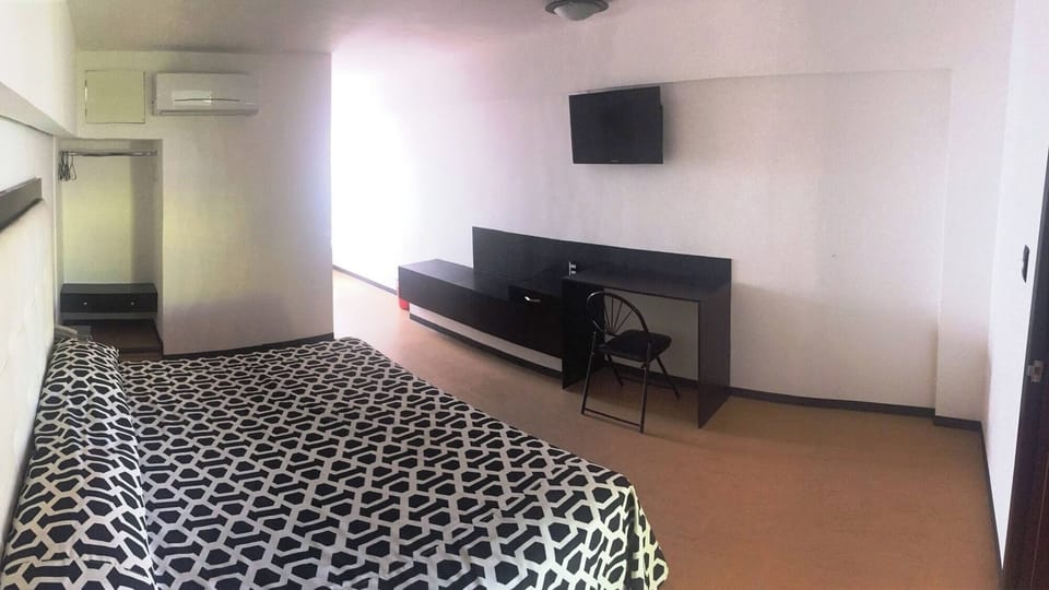 Settle in with a roomy layout, desk, and wall TV.