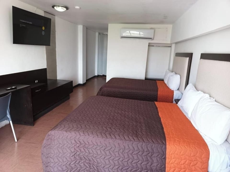 Recharge after exploring with twin beds and in-room TV.
