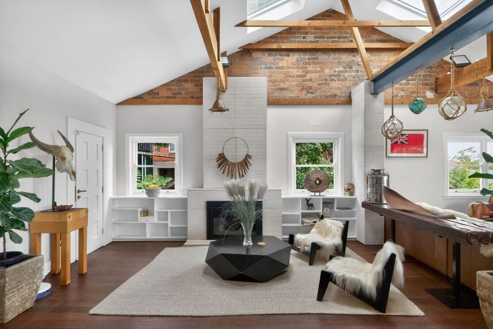 Living room with a gas fireplace, high ceilings, and a comfortable seating area.