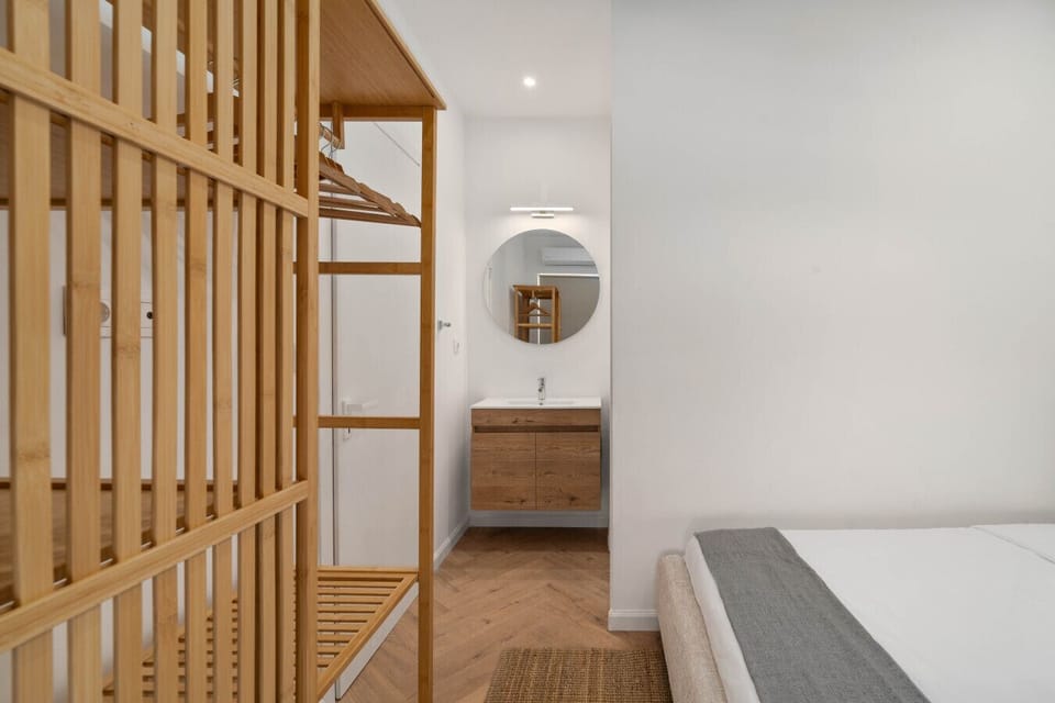 Warm stone and natural wood — a bathroom designed with the same care as the rest of the apartment.