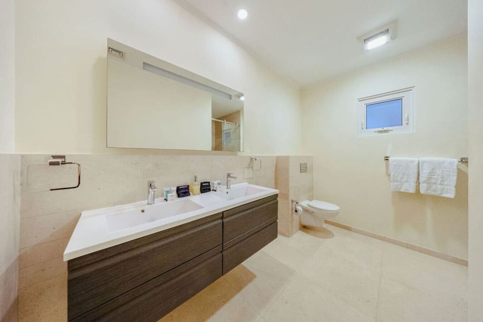 Spacious ensuite bathroom with double sinks—ideal for getting ready at the same time.