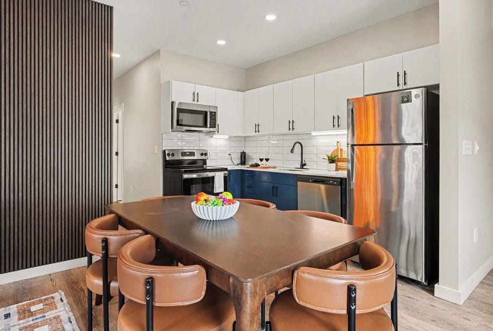 This modern kitchen features sleek stainless steel appliances, dining area for 6, and all the essentials you need for a comfortable and convenient stay. Open concept to living area. 