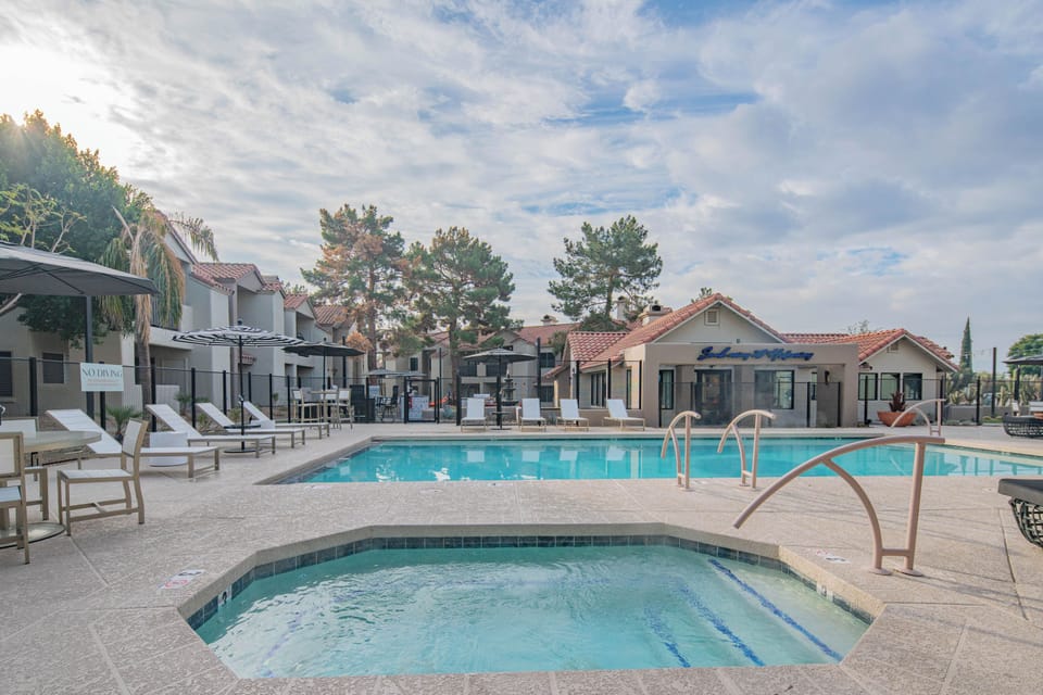 Relax by the resort-style community pool featuring a spa, lounge seating, and beautifully maintained surroundings.
