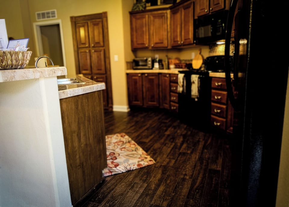Warm, spacious kitchen with rich wood cabinets and ample prep space