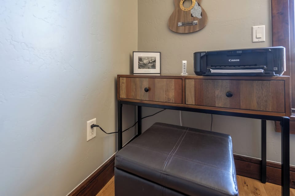 Your dedicated workspace with stylish mid-century desk and modern printer keeps you connected and productive during your stay.