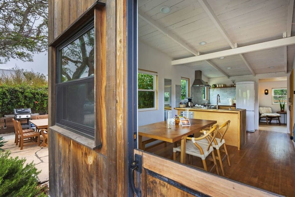 Through the Dutch door: the kitchen and dining table, with the patio right behind you.