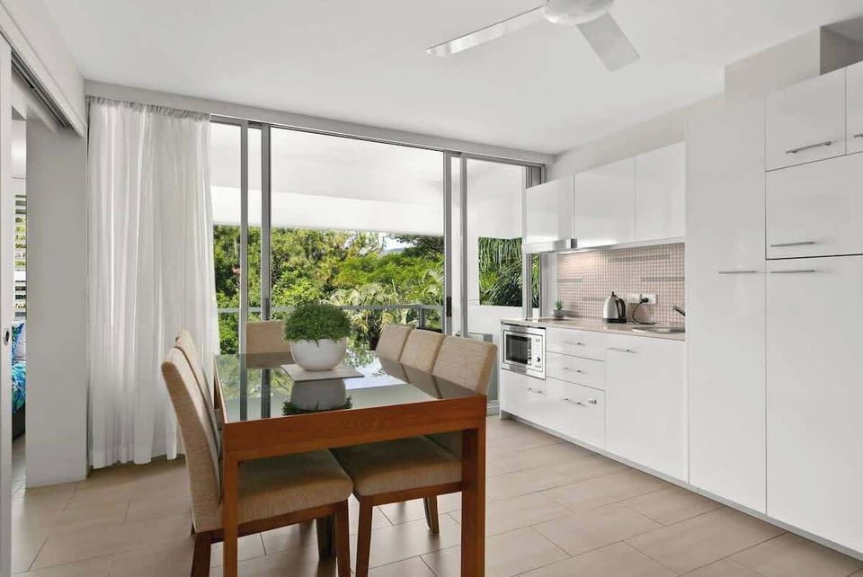 A large indoor dining table is set for six allowing guests ample space to come together for shared meal.