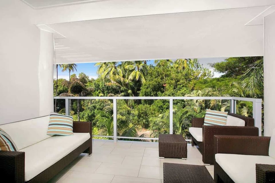 Relax after a big day out on the private balcony. It frames lush tropical views and has comfortable outdoor seating.