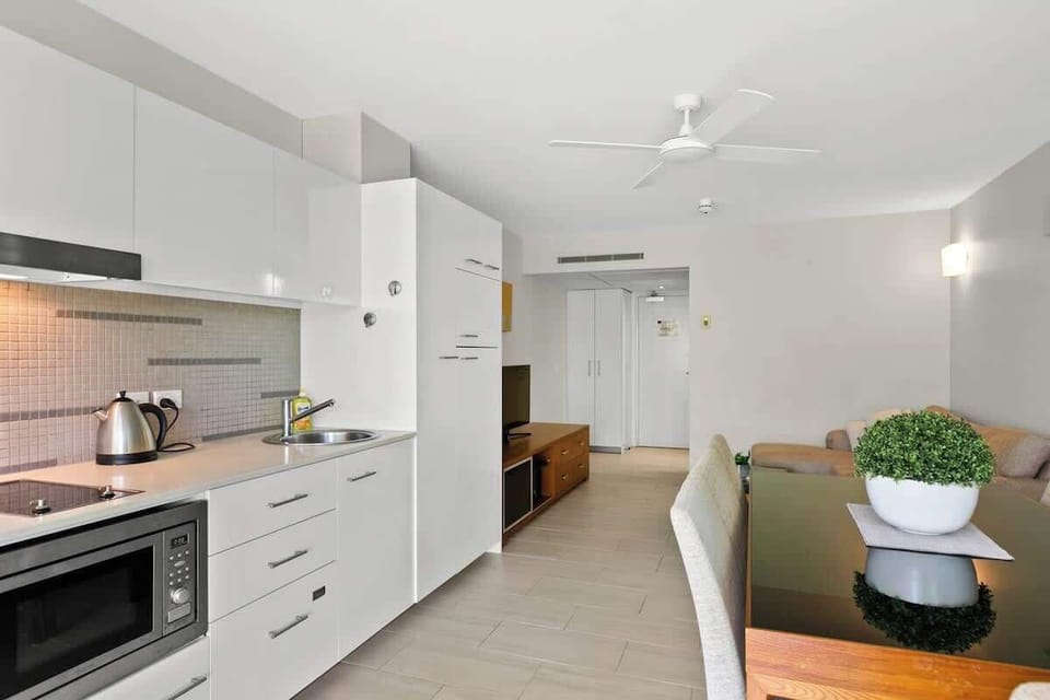The compact kitchen is equipped with the appliances and utensils you'll need to cook a meal at home. It includes a fridge, stove, microwave and dishwasher.