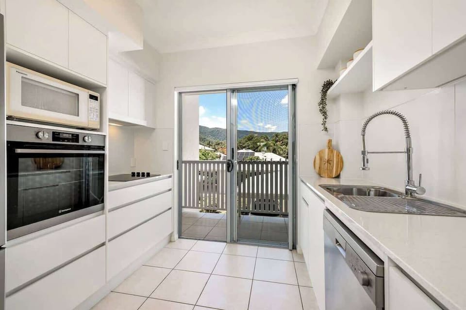A spacious kitchen equipped with modern appliances and plenty of counter space makes meal preparation a breeze.