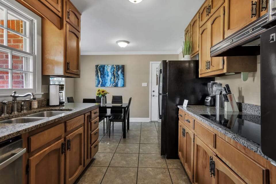 This bright kitchen offers a full-size fridge, stove, and essentials, making it easy to cook, gather, and enjoy time together.