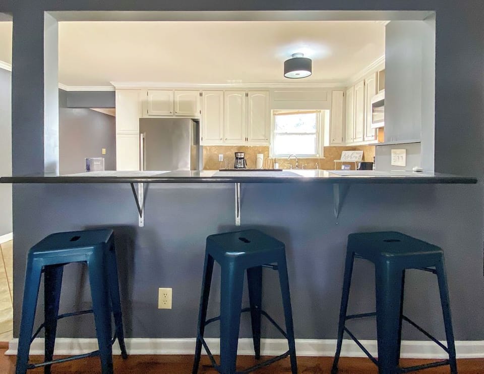 Additional bar seating with three stools gives kids and guests a casual place to eat, chat, or keep the cook company.
