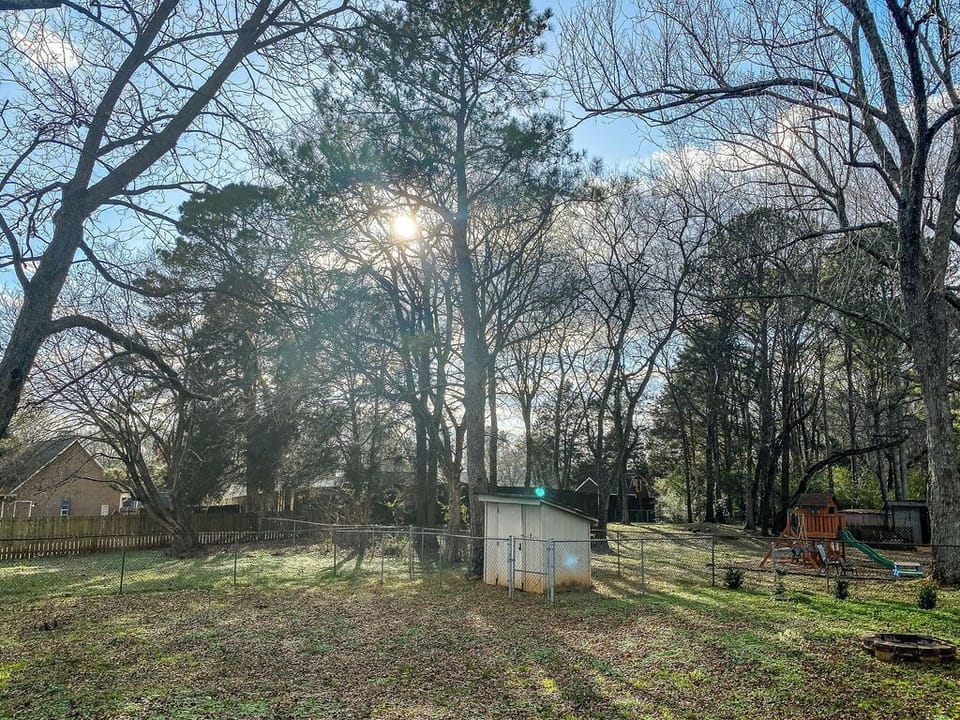 The fully fenced backyard gives you a private space to relax, grill, or gather around the fire pit after a long day.