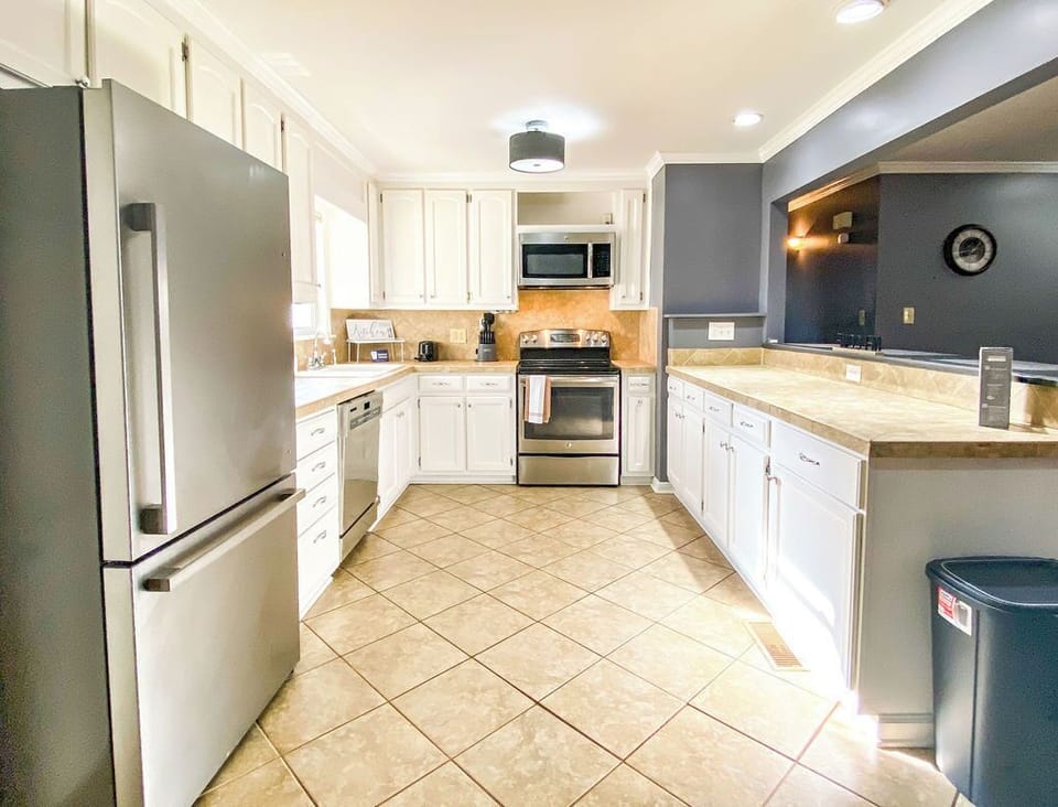 The fully stocked kitchen features stainless steel appliances and everything you need to cook and dine with ease.