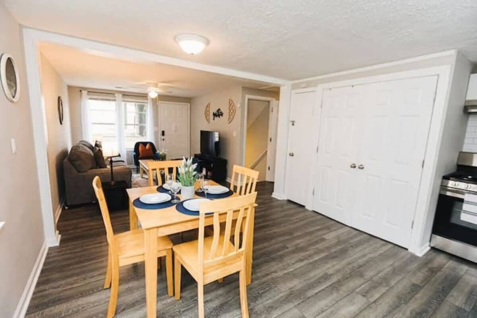 Light wood dining table with seating for four, offering a bright and inviting space for meals or casual conversation.