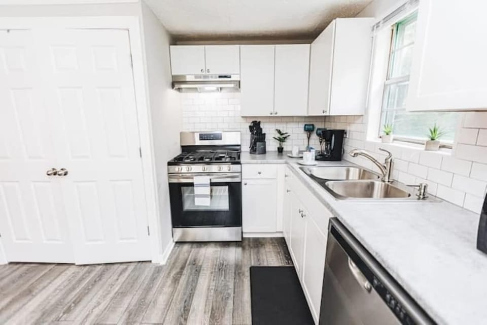 The kitchen opens up with a spacious layout, featuring stainless steel appliances, clean finishes, and plenty of room to cook, prep, and gather.