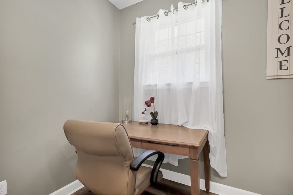 Laundry area doubles as a functional workspace, giving you a convenient spot to catch up on emails or get a little work done while staying close to everyday essentials.