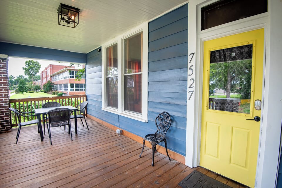 Your stay begins here! Step onto the welcoming front porch, unlock the smart lock on the bright yellow door, and make yourself at home. It's the perfect spot to sip your morning coffee or unwind after a day out.