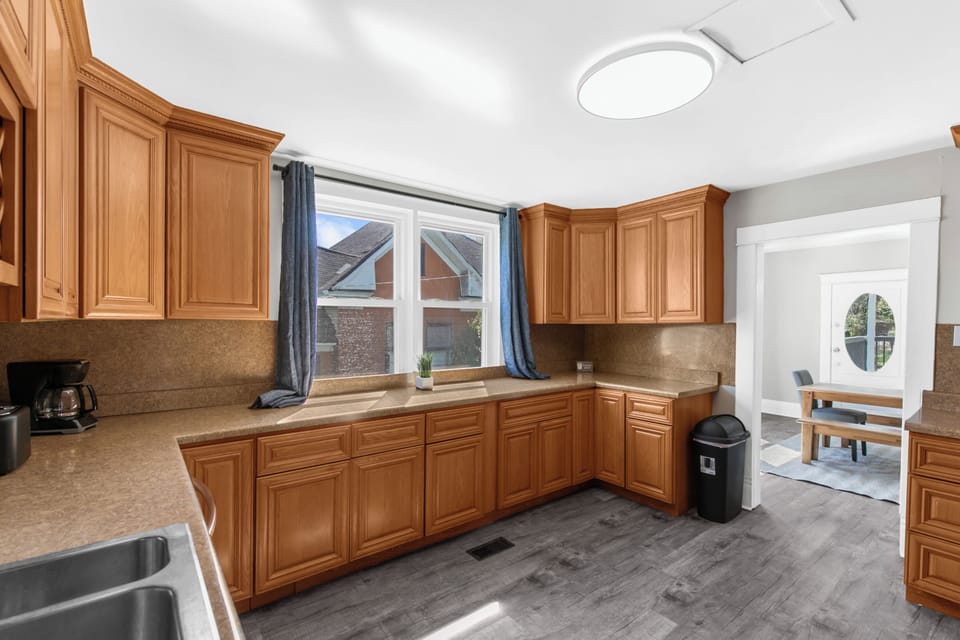 This spacious kitchen offers plenty of cabinet and counter space, making it easy to cook, prep, and gather all in one place.