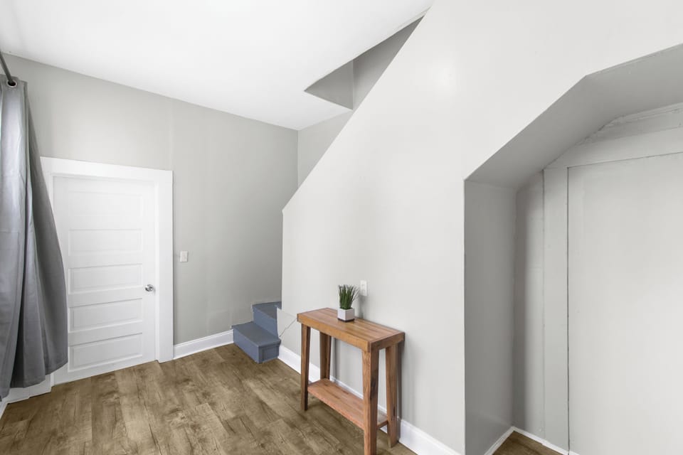 The interior back staircase provides easy access between levels, connecting the main floor to the upstairs bedrooms while maintaining the home’s classic, functional layout.