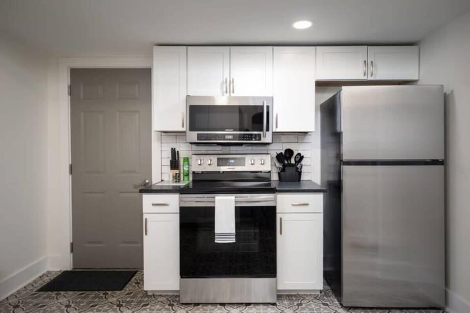 Cook with ease in the fully equipped kitchen, featuring sleek stainless steel appliances and everything you need for meals at home.