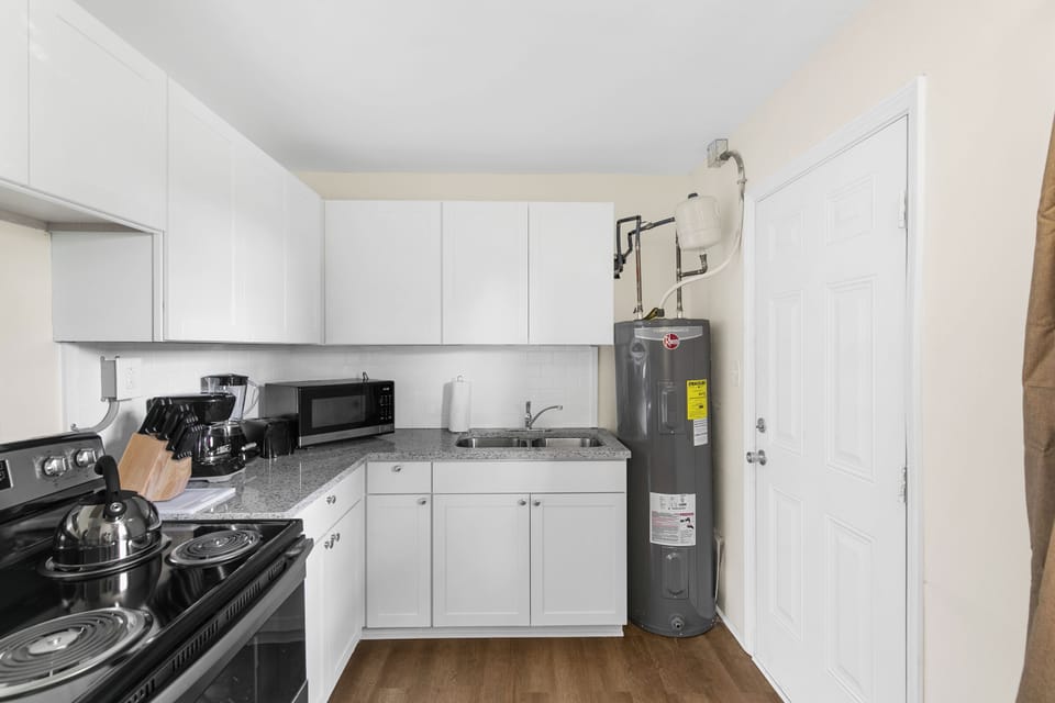 Pulling back for a full view of the kitchen—plenty of cabinet space and stainless appliances, all set up and ready to go.