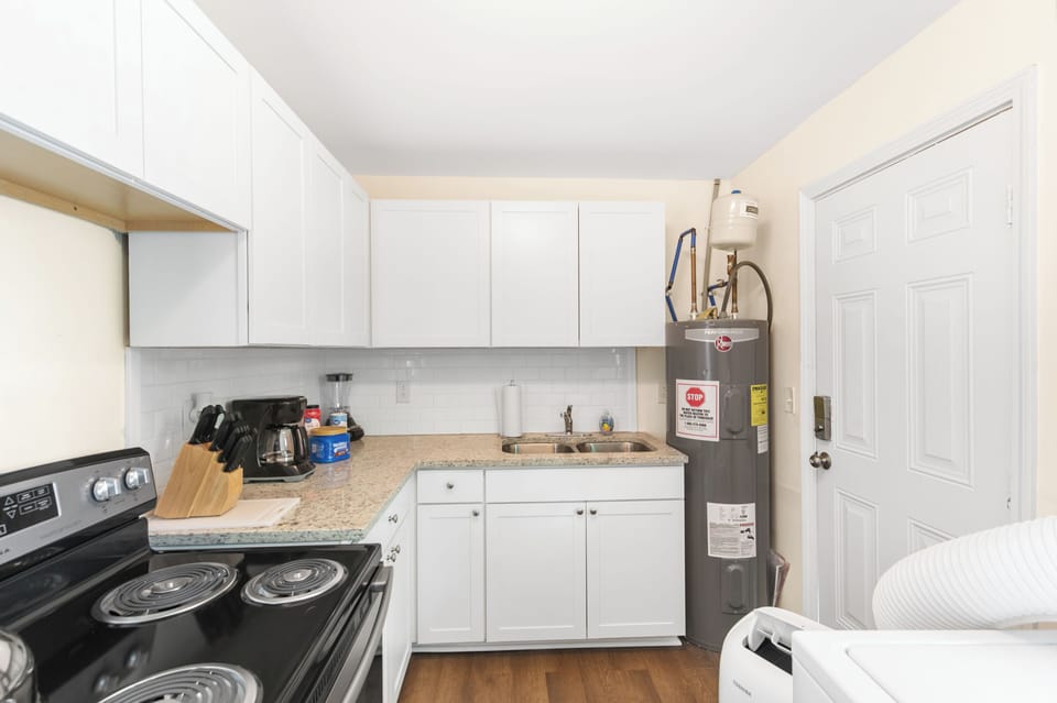 The kitchen is fully equipped for everyday use and includes a grill stored inside for convenience—easily moved just outside the back door when you’re ready to use it.