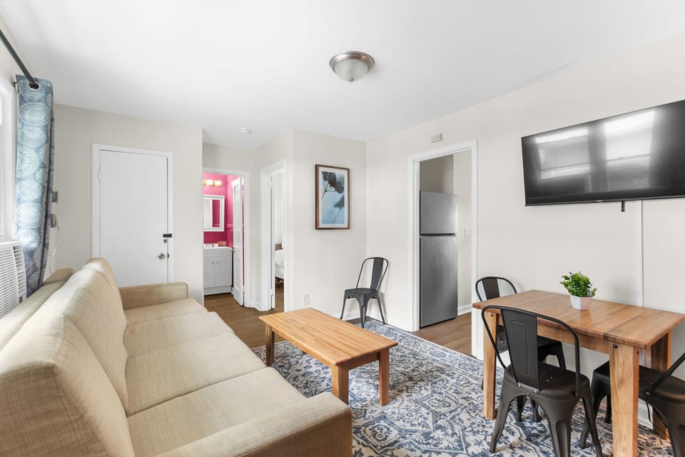 Pulling back a bit so you can see how it all connects—the dining nook, couch, and living space working together.
