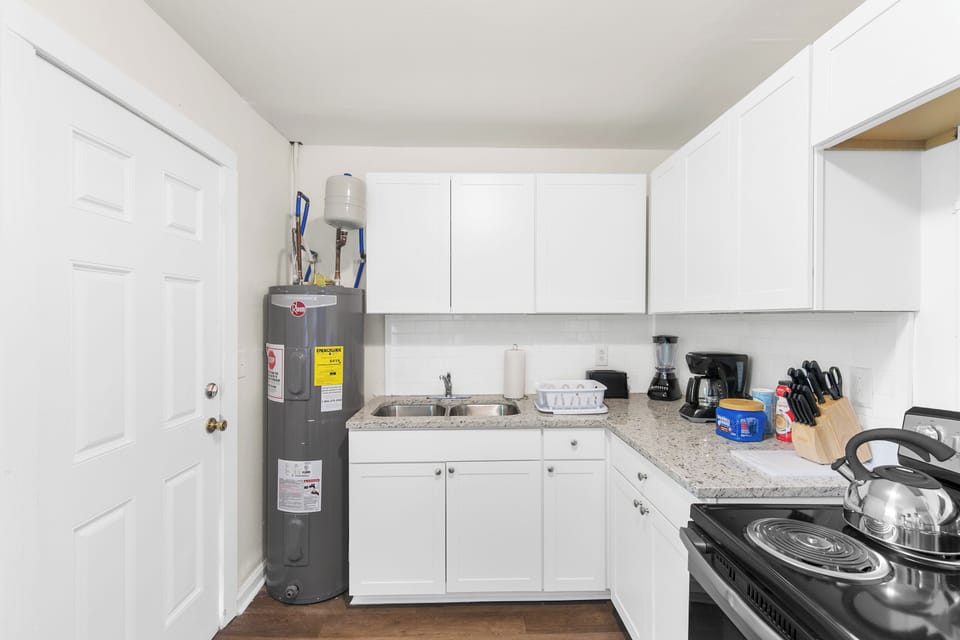 The kitchen is fully equipped for everyday use and includes a grill stored inside for convenience—easily moved just outside the back door when you’re ready to use it.