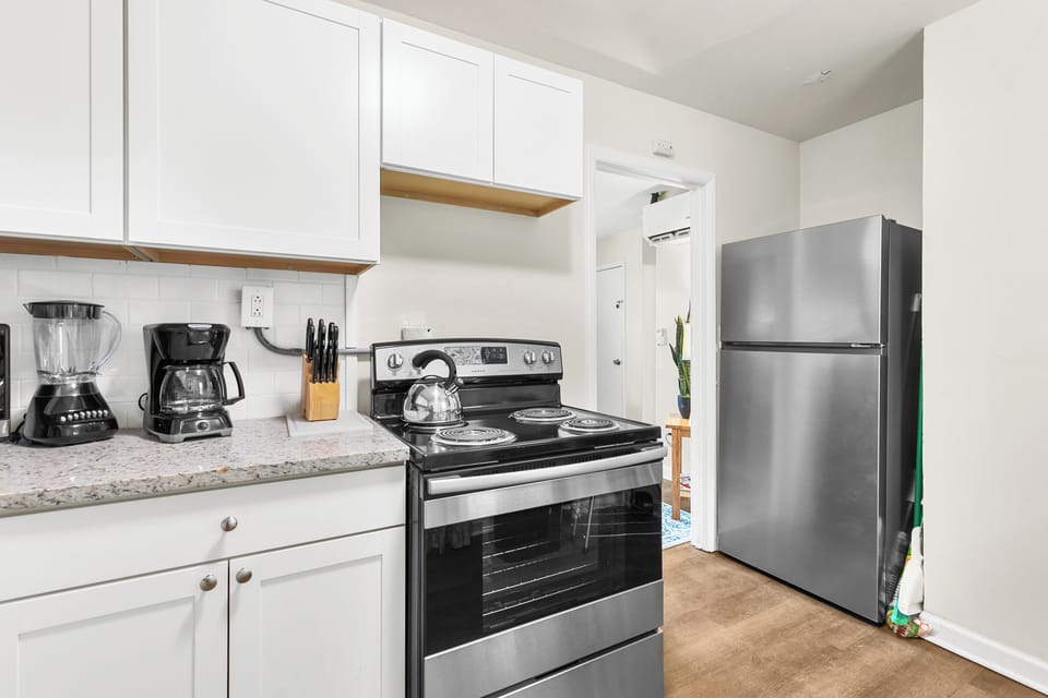Pulling back for a full view of the kitchen—plenty of cabinet space and stainless appliances, all set up and ready to go.