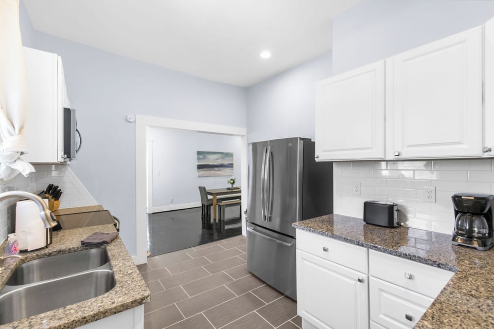 Step into a bright, functional kitchen with sleek stainless steel appliances—everything you need to cook a full meal or just reheat leftovers and keep things easy.