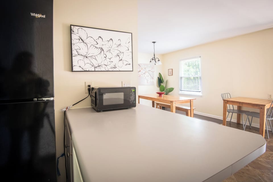 The open layout keeps everyone connected. Chat with the cook from the breakfast table, grab a quick snack, or gather around while planning the day's adventures.