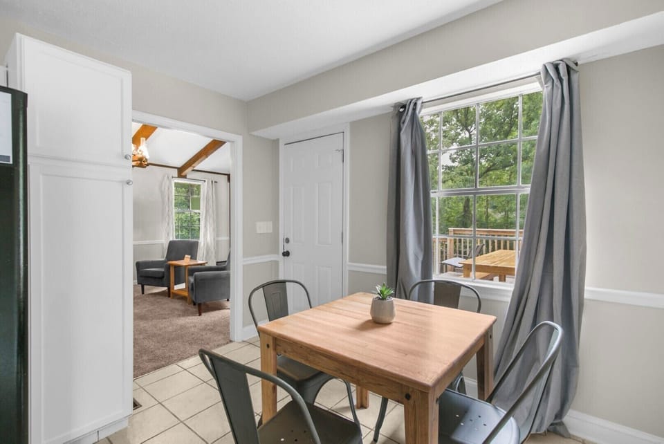The upstairs dining area offers a comfortable setting for four, perfectly positioned within the kitchen space for easy, connected meals and conversation.