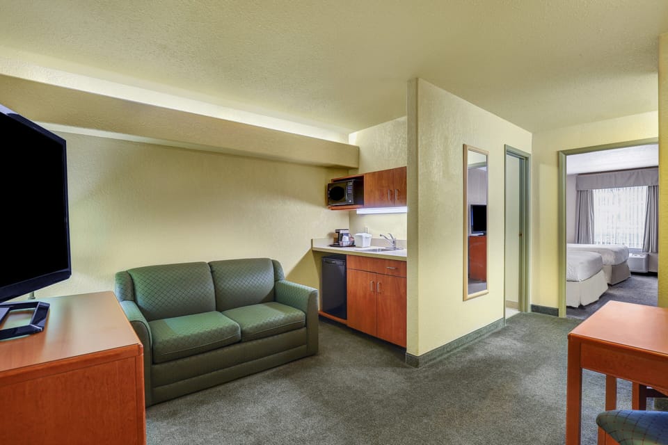 Suite, 1 Bedroom | Desk, blackout drapes, iron/ironing board, free WiFi