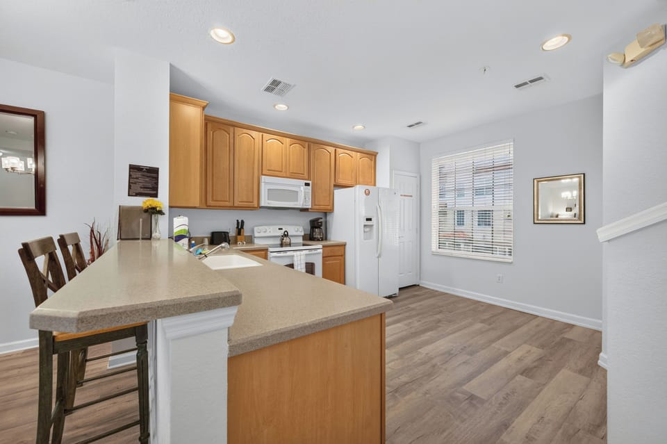 Step into your fully equipped kitchen, complete with modern appliances, ample counter space, and a convenient breakfast bar—perfect for whipping up meals and sharing stories over morning coffee.
